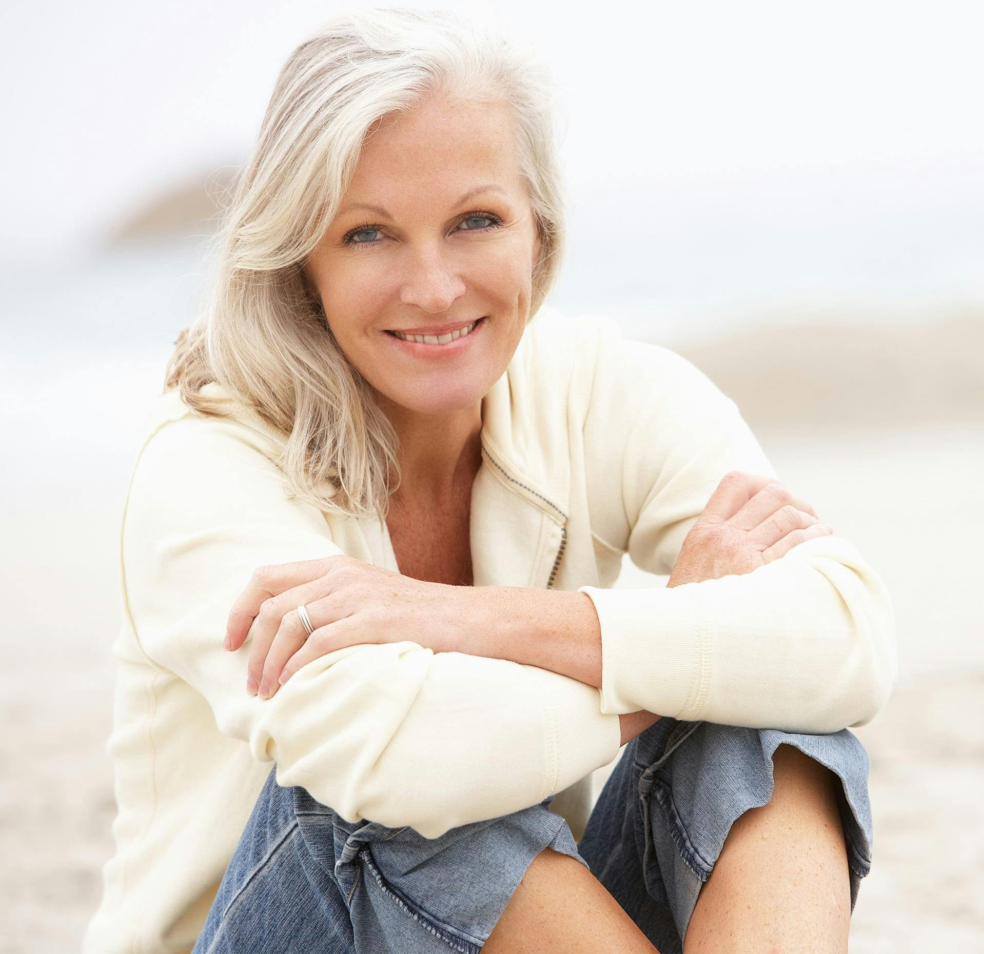 woman with white hair smiling at the camera
