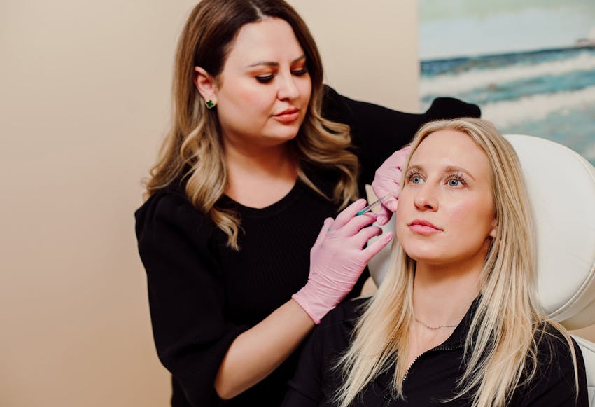 woman injecting another woman in her crows feet
