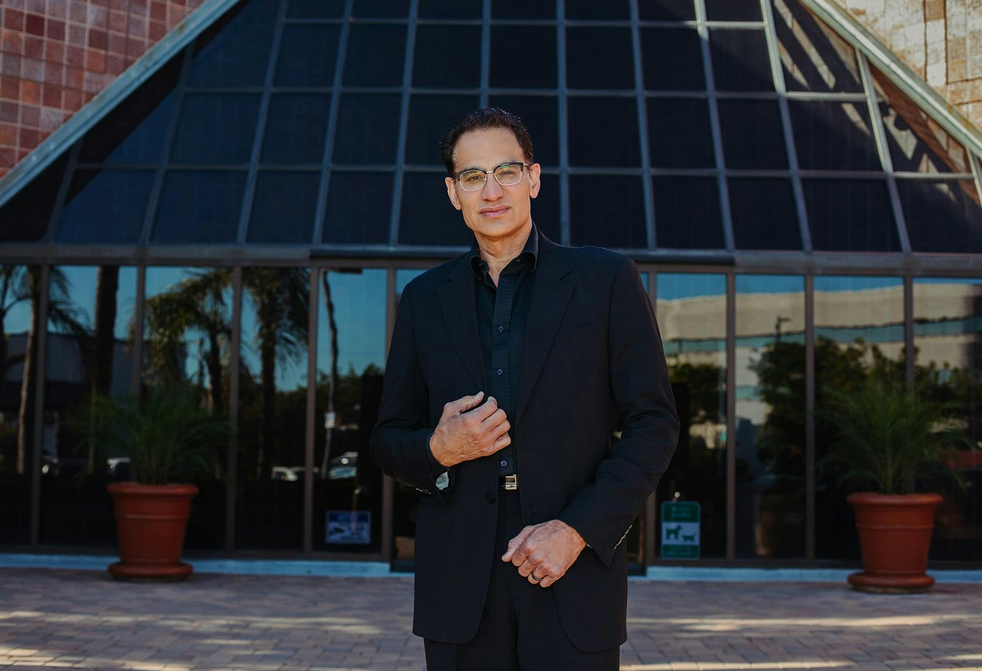 Dr. Moradi standing in front of a building
