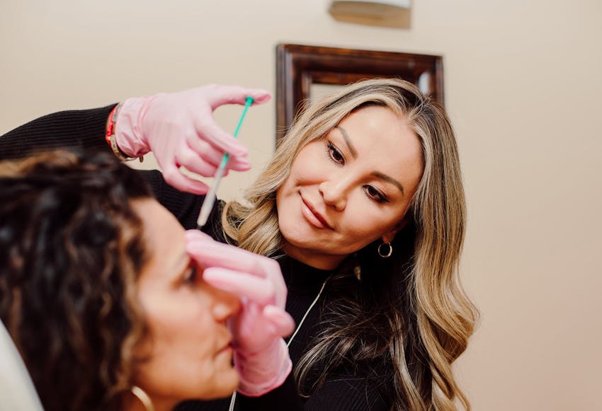 woman getting an injection in her forehead
