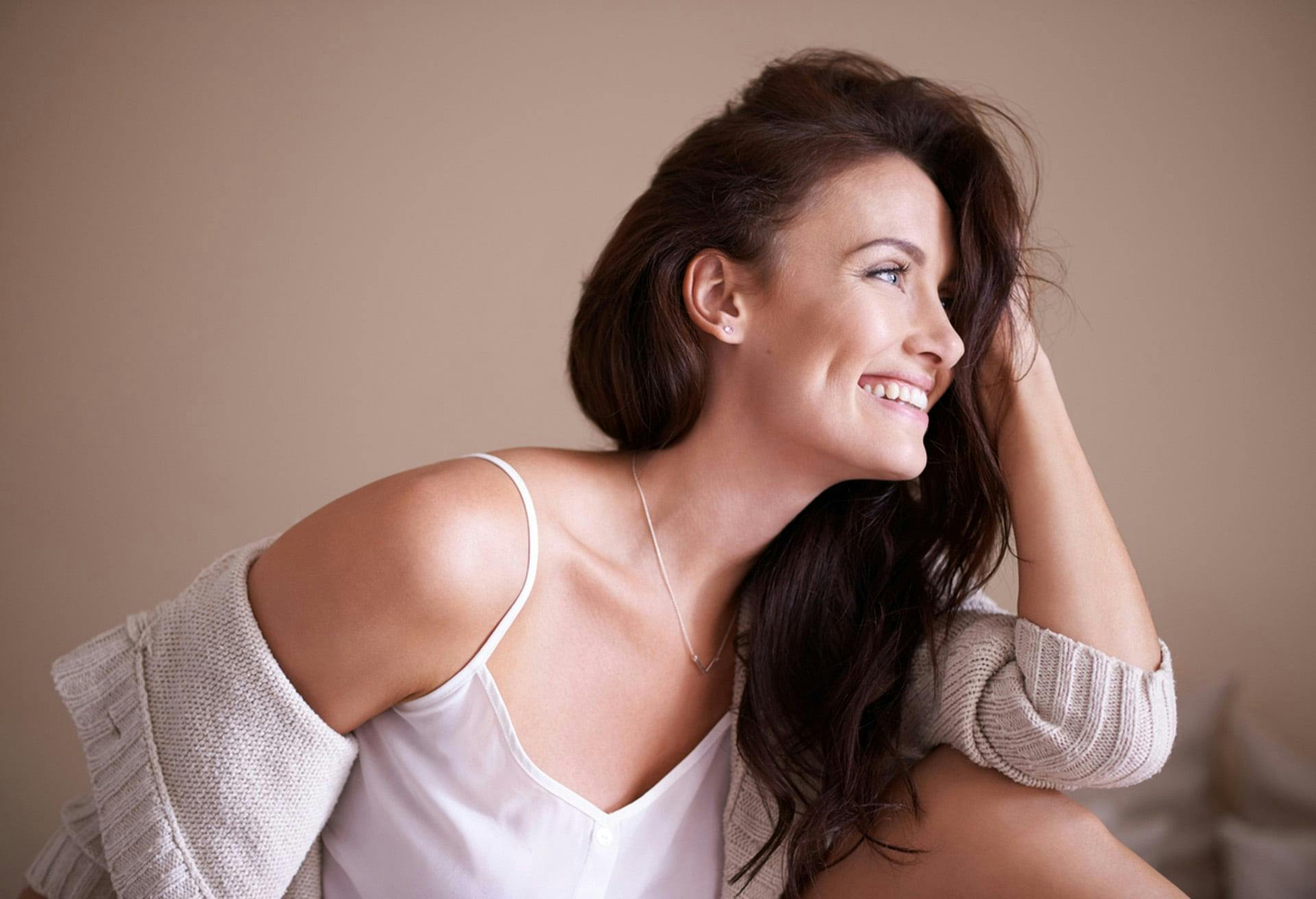 Woman looking to the side with her hand in her hair