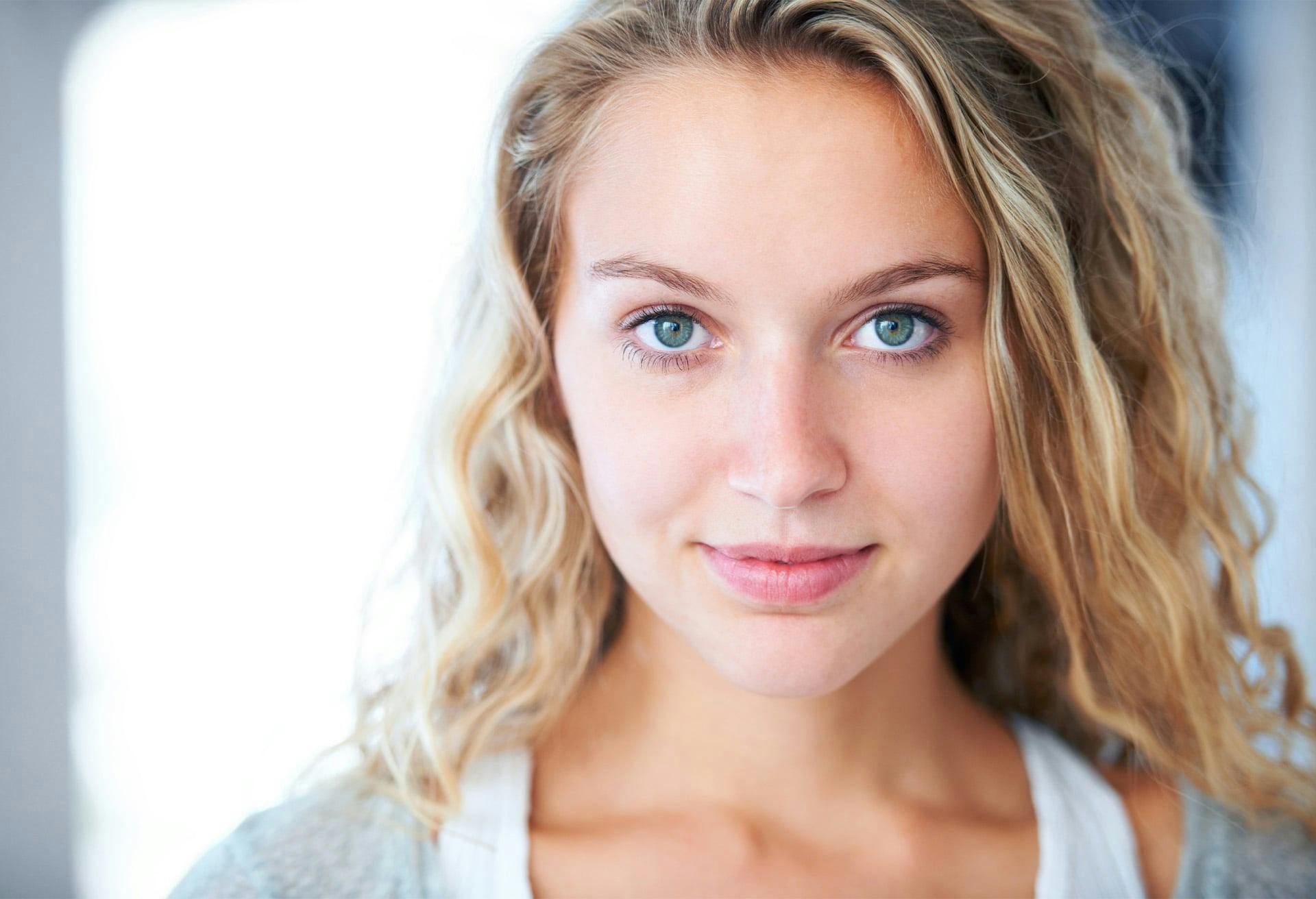 woman with blonde curly hair and blue eyes
