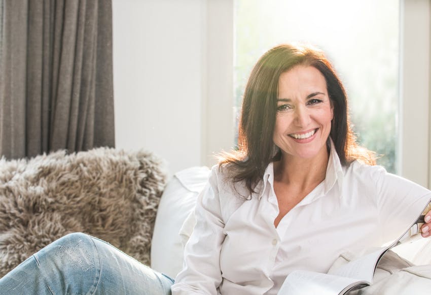 woman smiling sitting on a couch