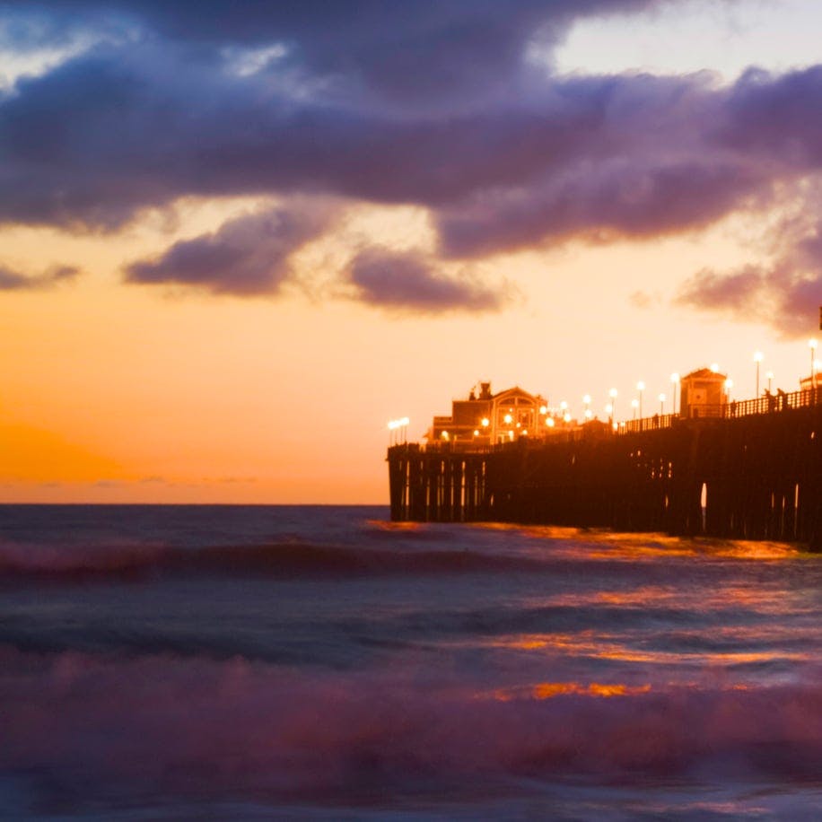a dock with the sunset in the background