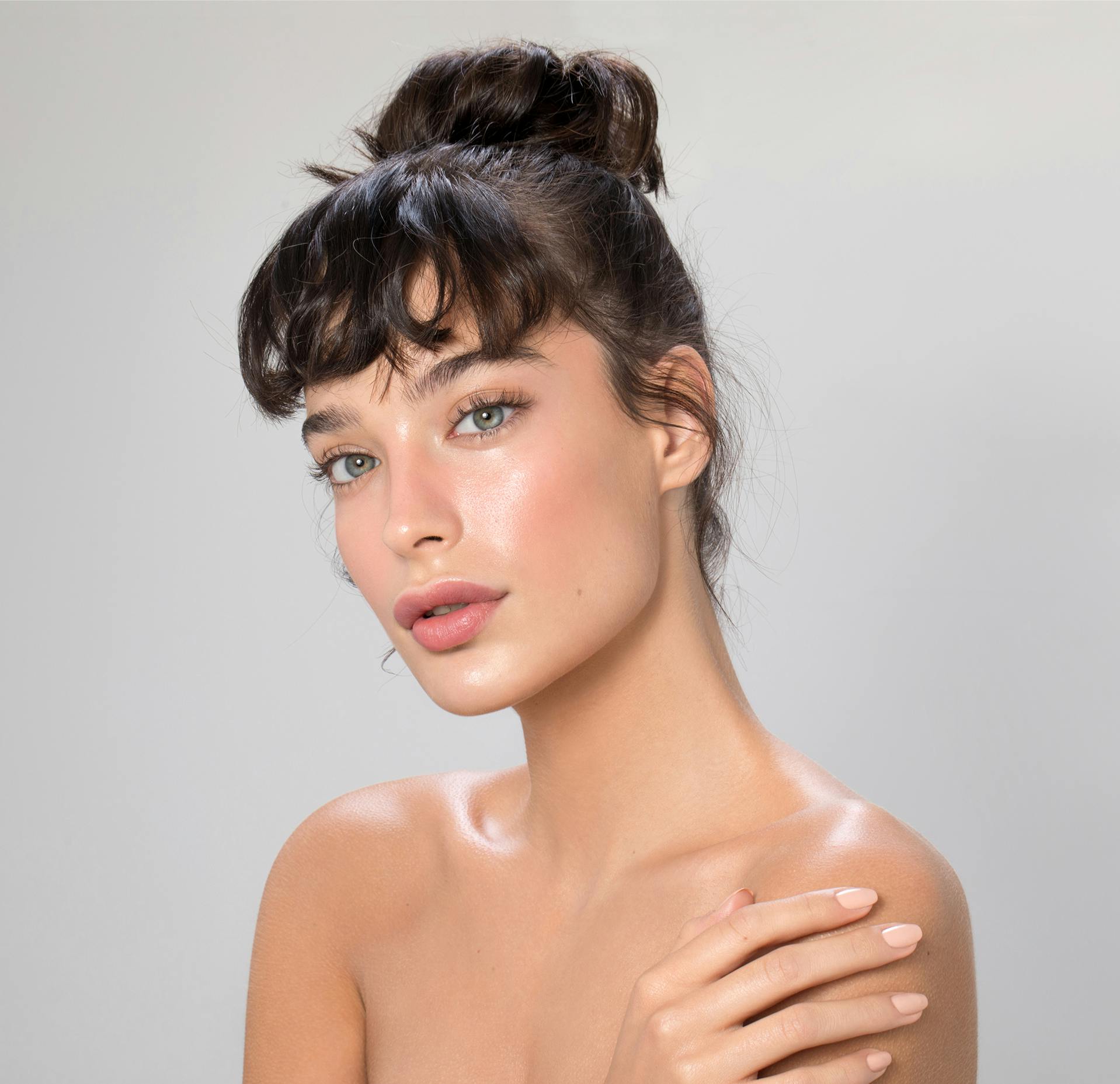 Woman with her hand against her shoulder