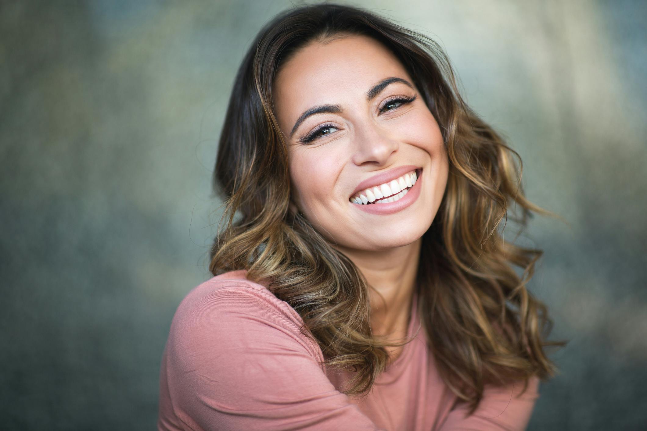 woman with curly hair smiling