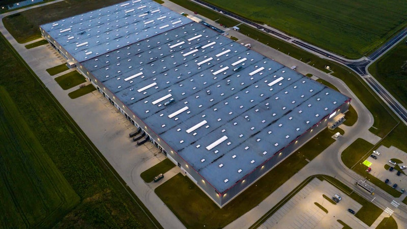 Commercial real estate with solar and energy storage on top shot at night.