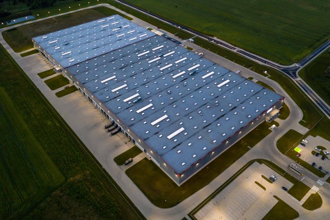 Commercial real estate with solar and energy storage on top shot at night.