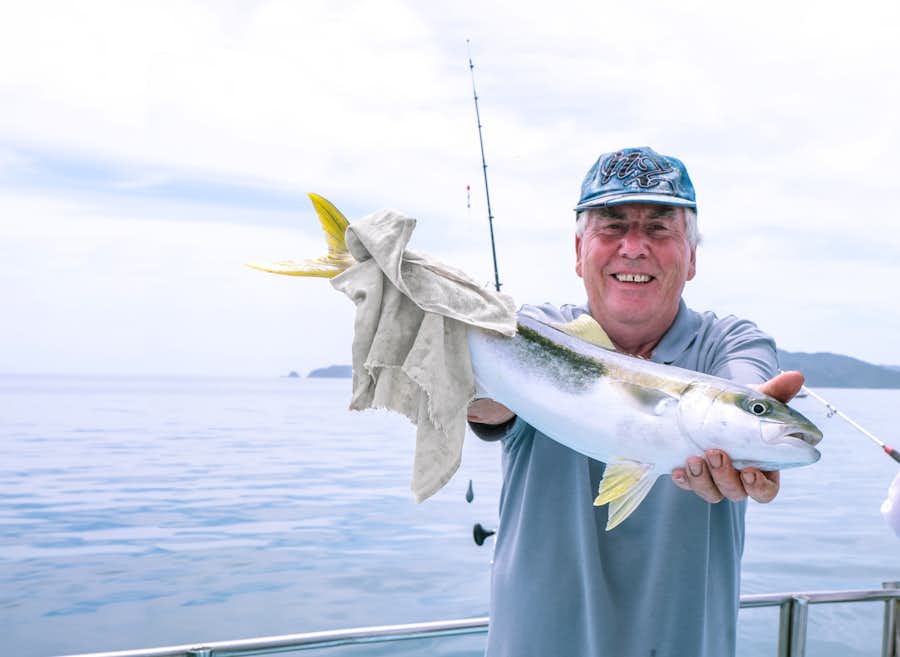 catching a fish on a boat in new zealand