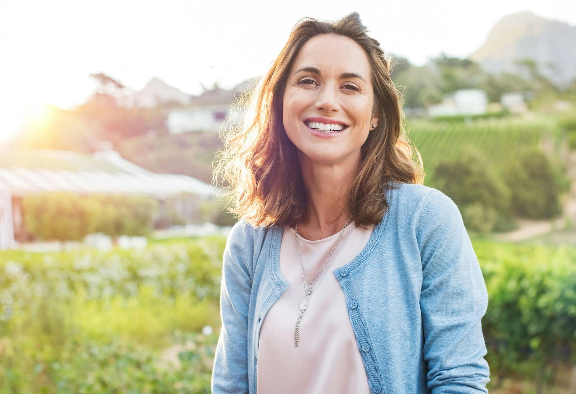 Patient Smiling with a Field Behind Her