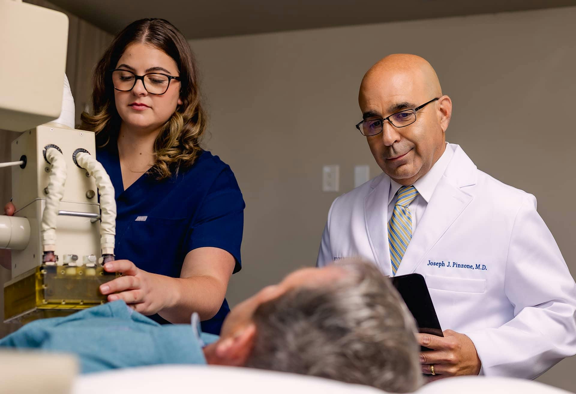 Dr. Pinzone and a nurse with a patient