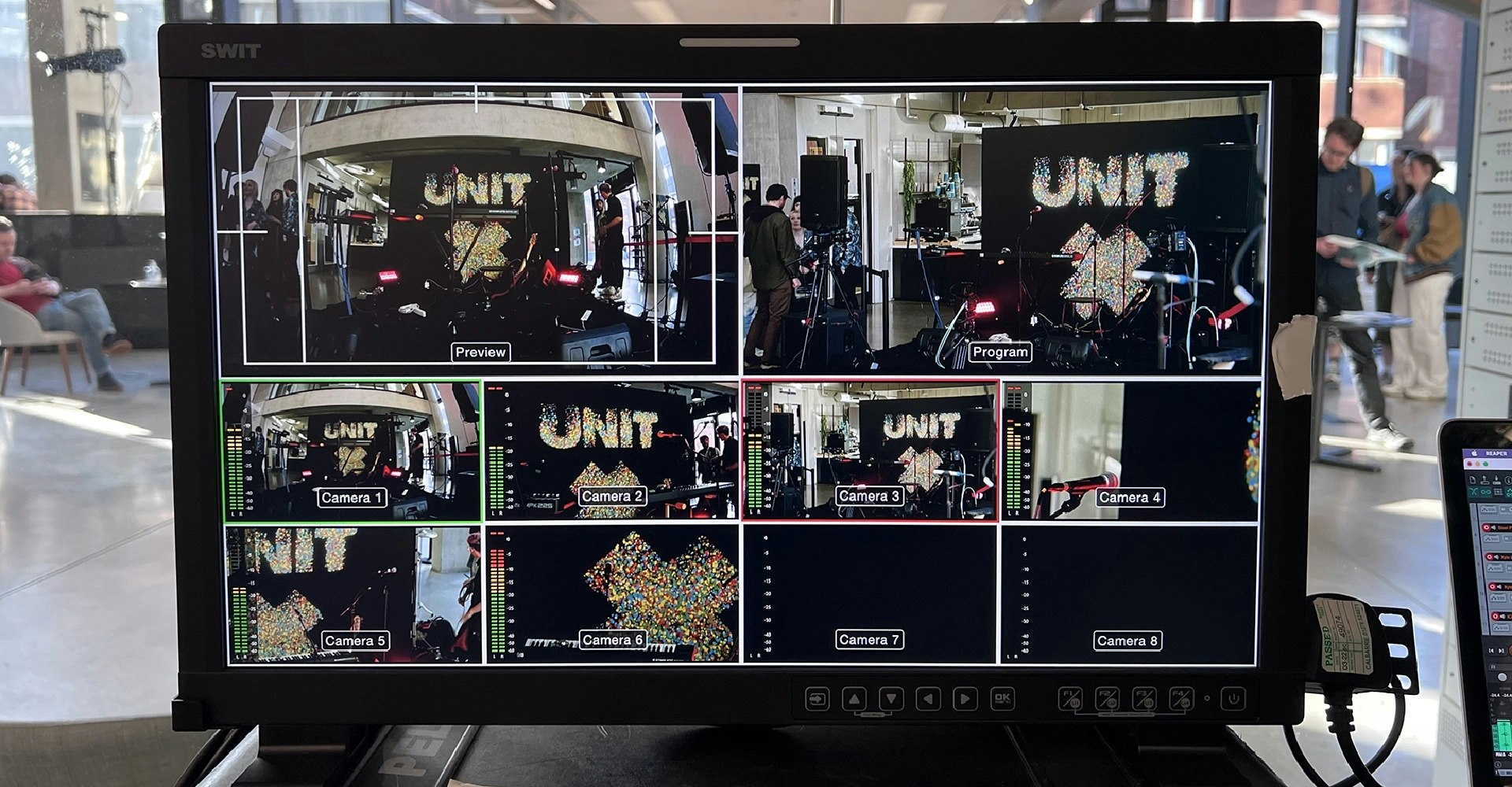 Screen with multiple shots and angles of the Unit X exhibition poster