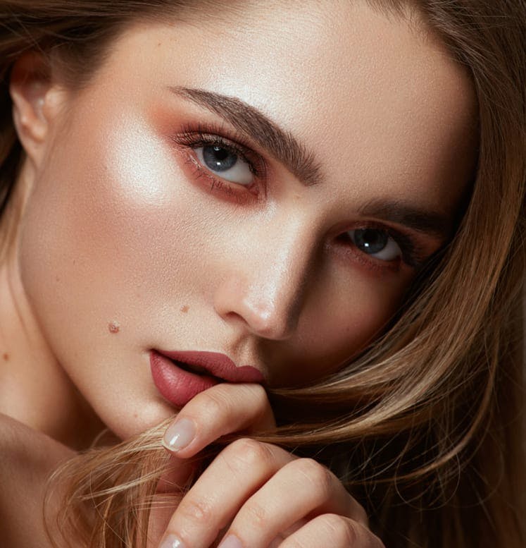 Beautiful woman touching her fingers to her lips