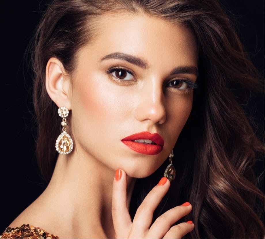 Woman with curly hair wearing red lipstick