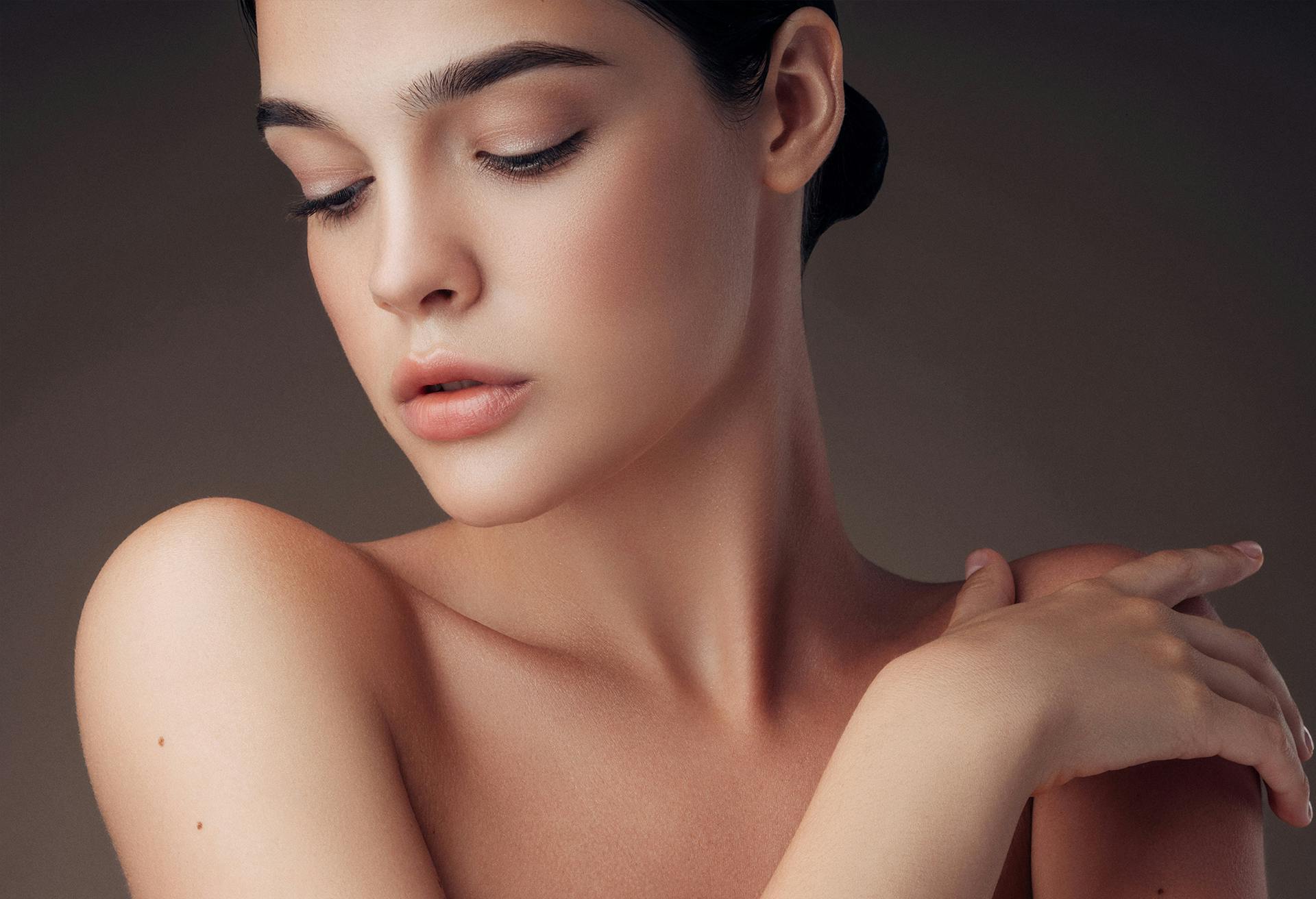 woman touching bare shoulder
