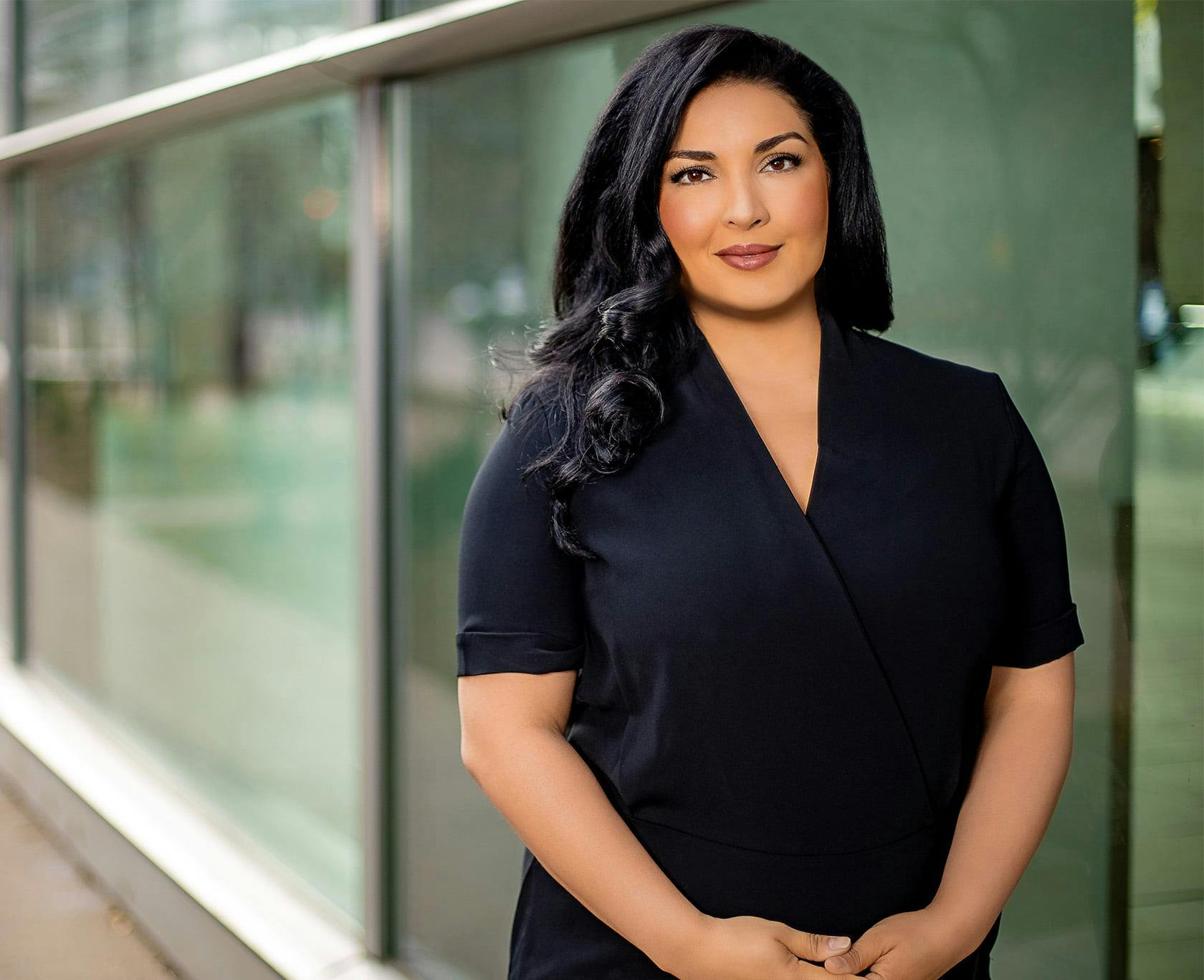 Dr. Lily Daniali standing in front of windows