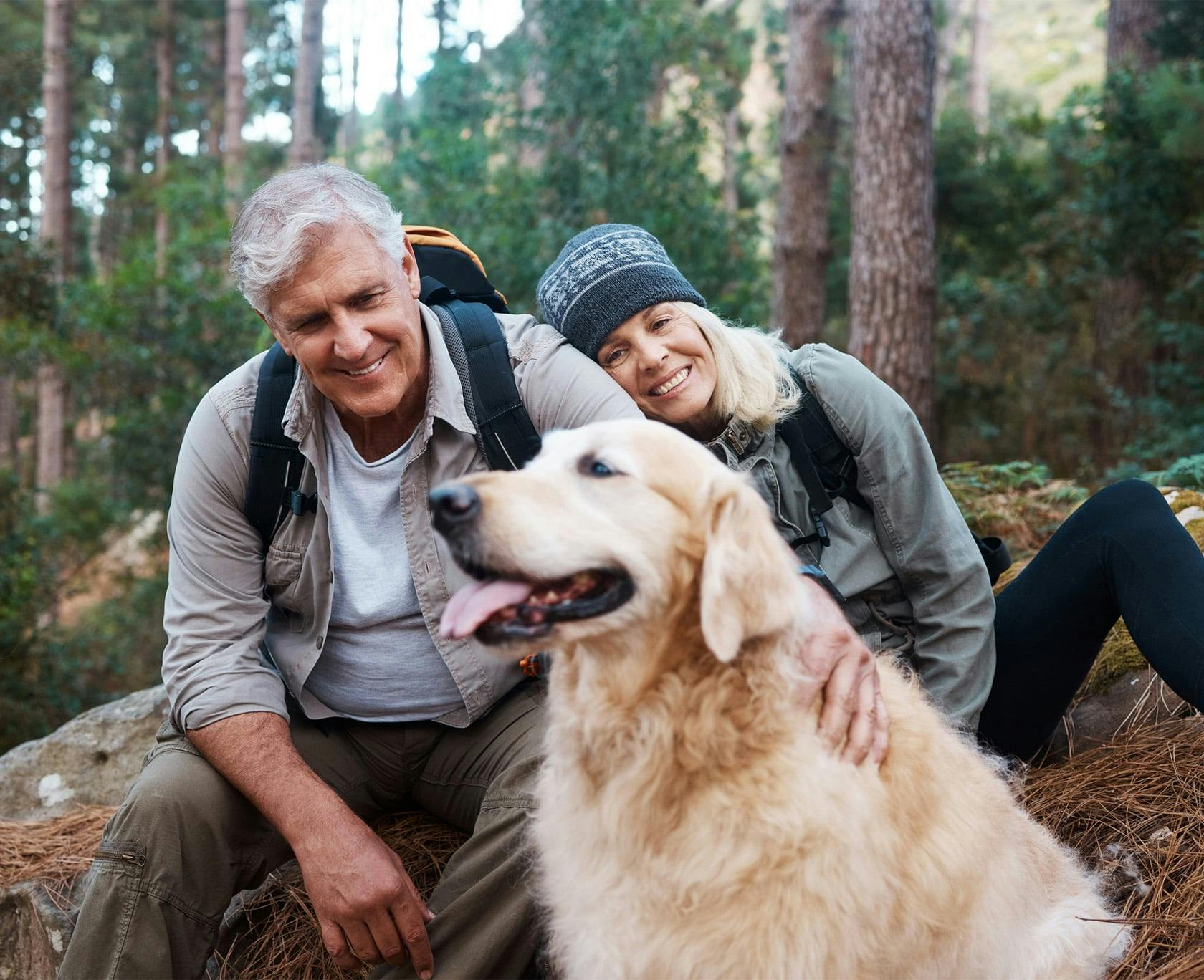 Man and woman on a hike with their dog