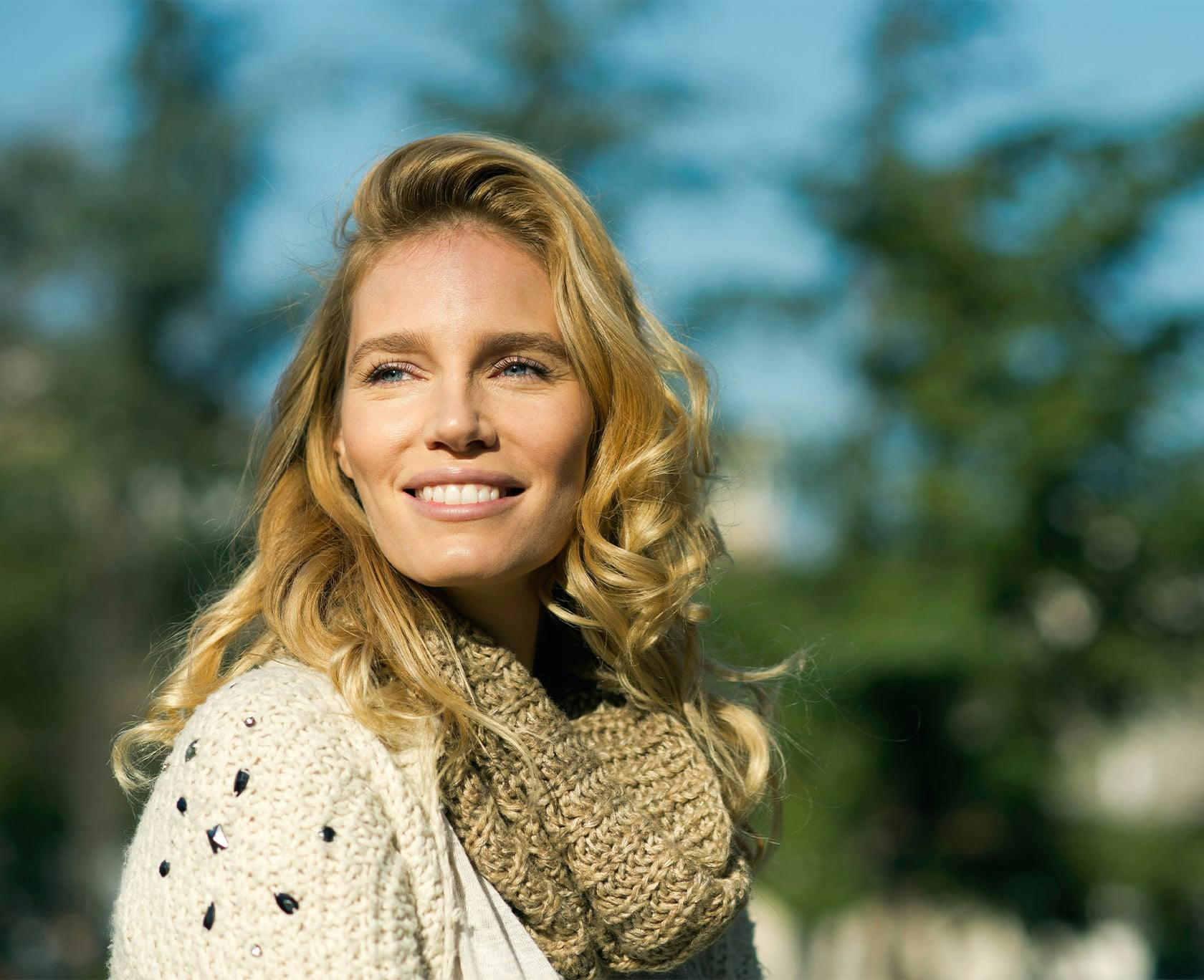 Blonde woman in a scarf smiling