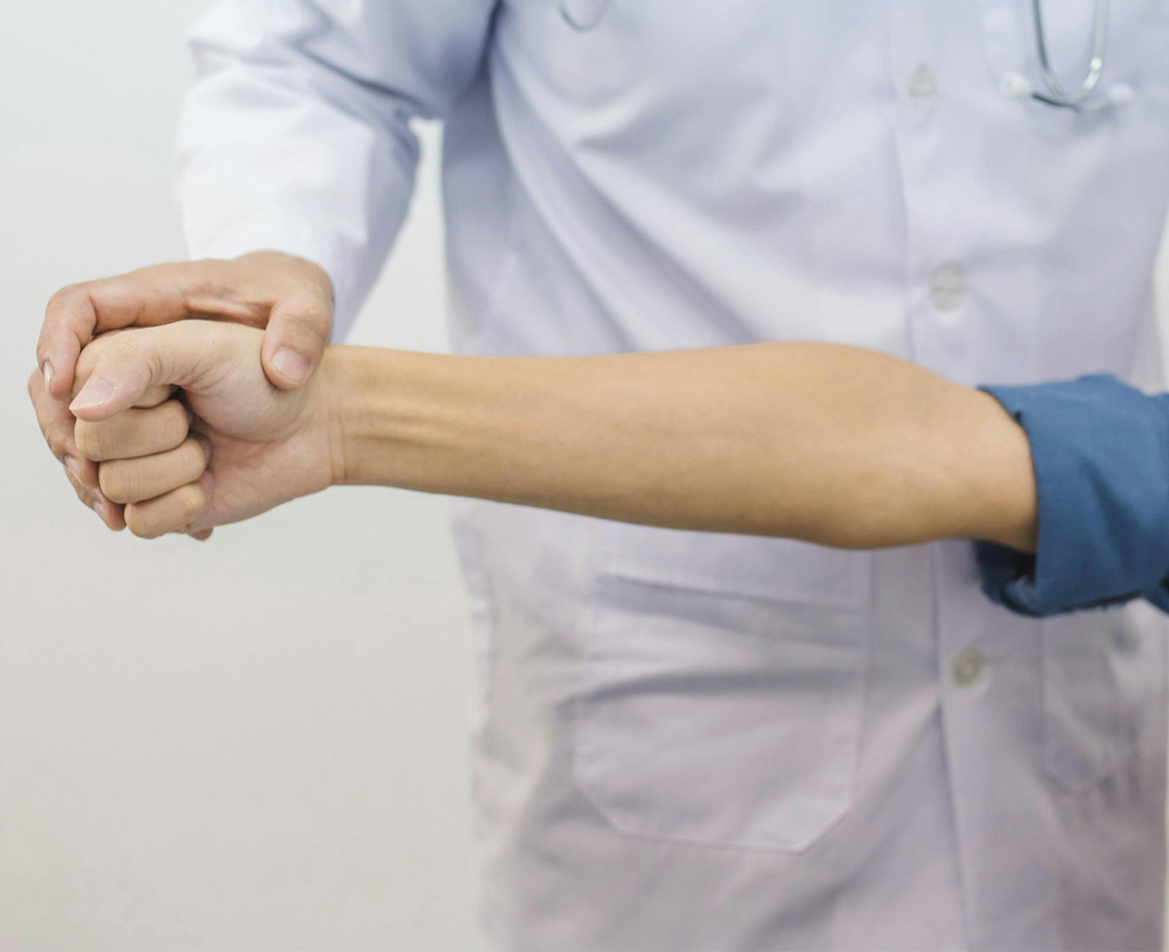 Doctor examining a womans arm