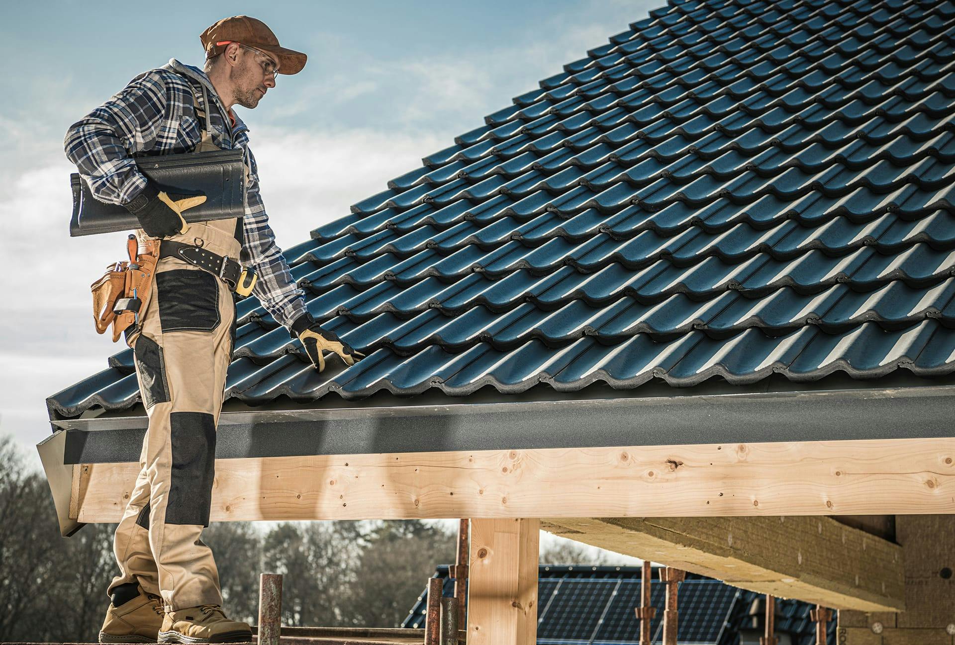 man on a roof with a tool