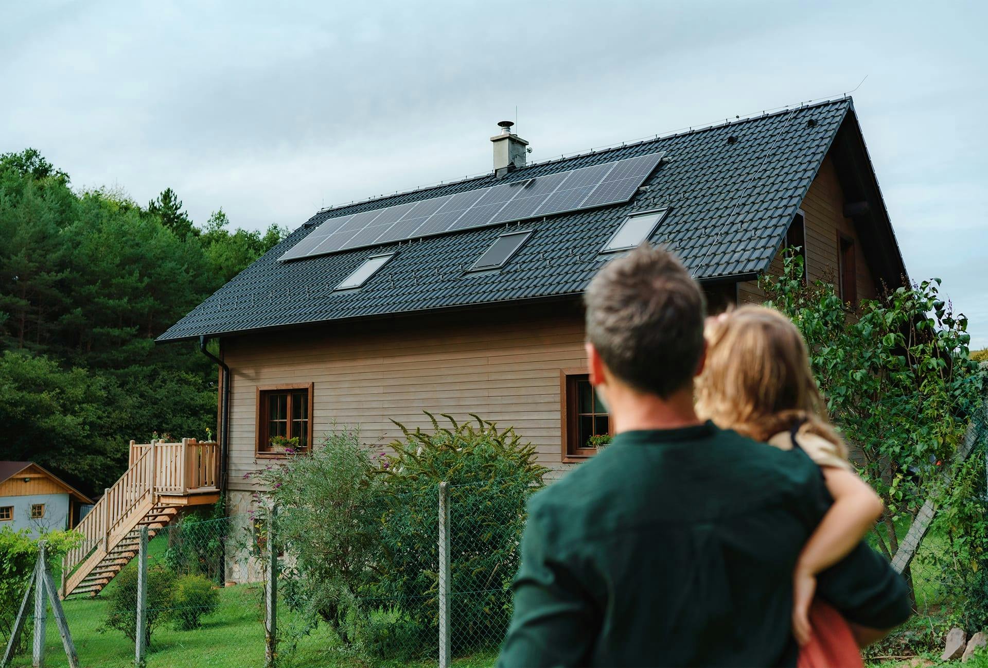 there is a man and a woman standing in front of a house