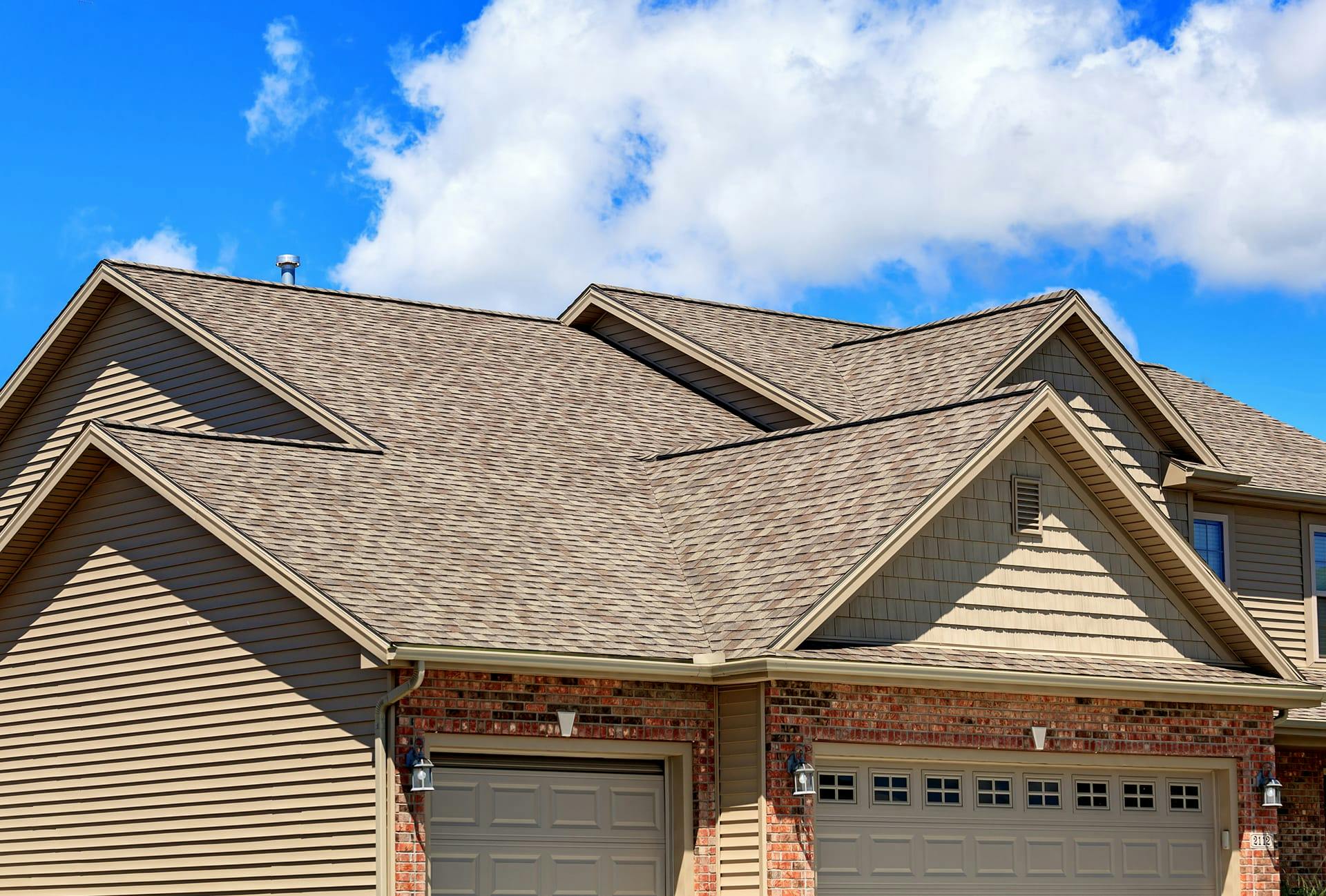 roof on a house with a garage and a driveway