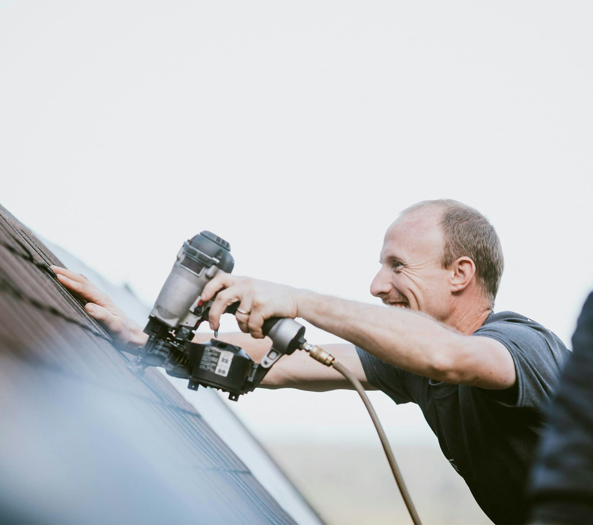 Man nailing on a roof