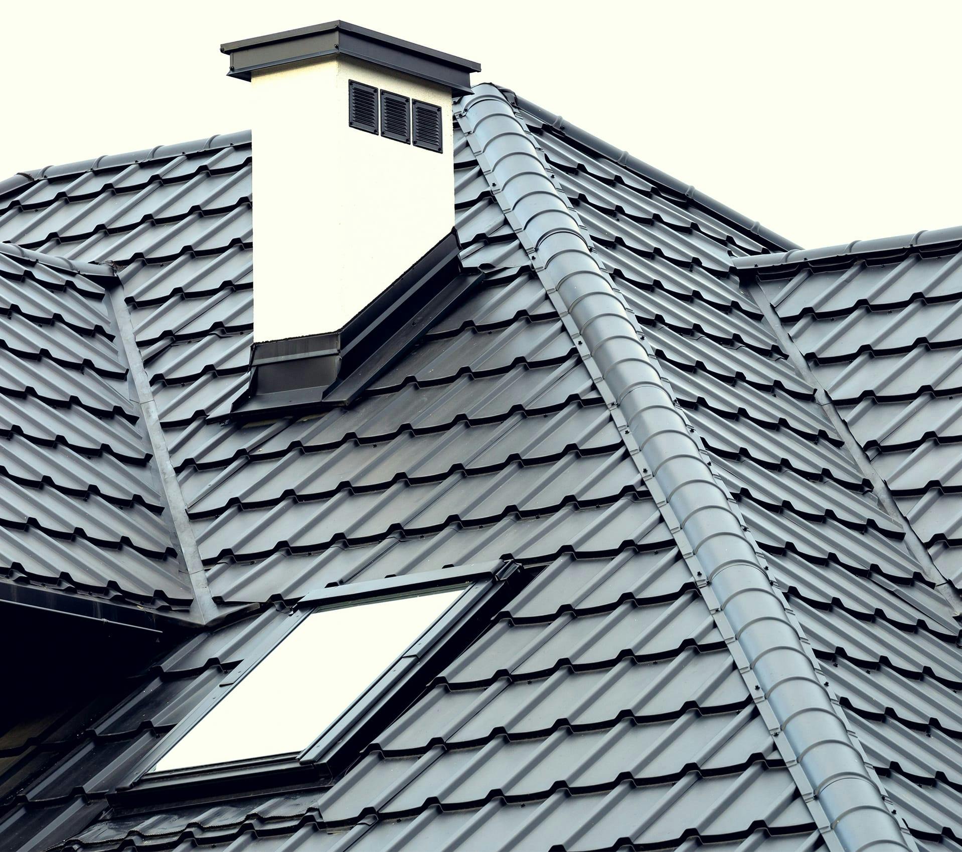 a close up of a roof with a chimney and a window