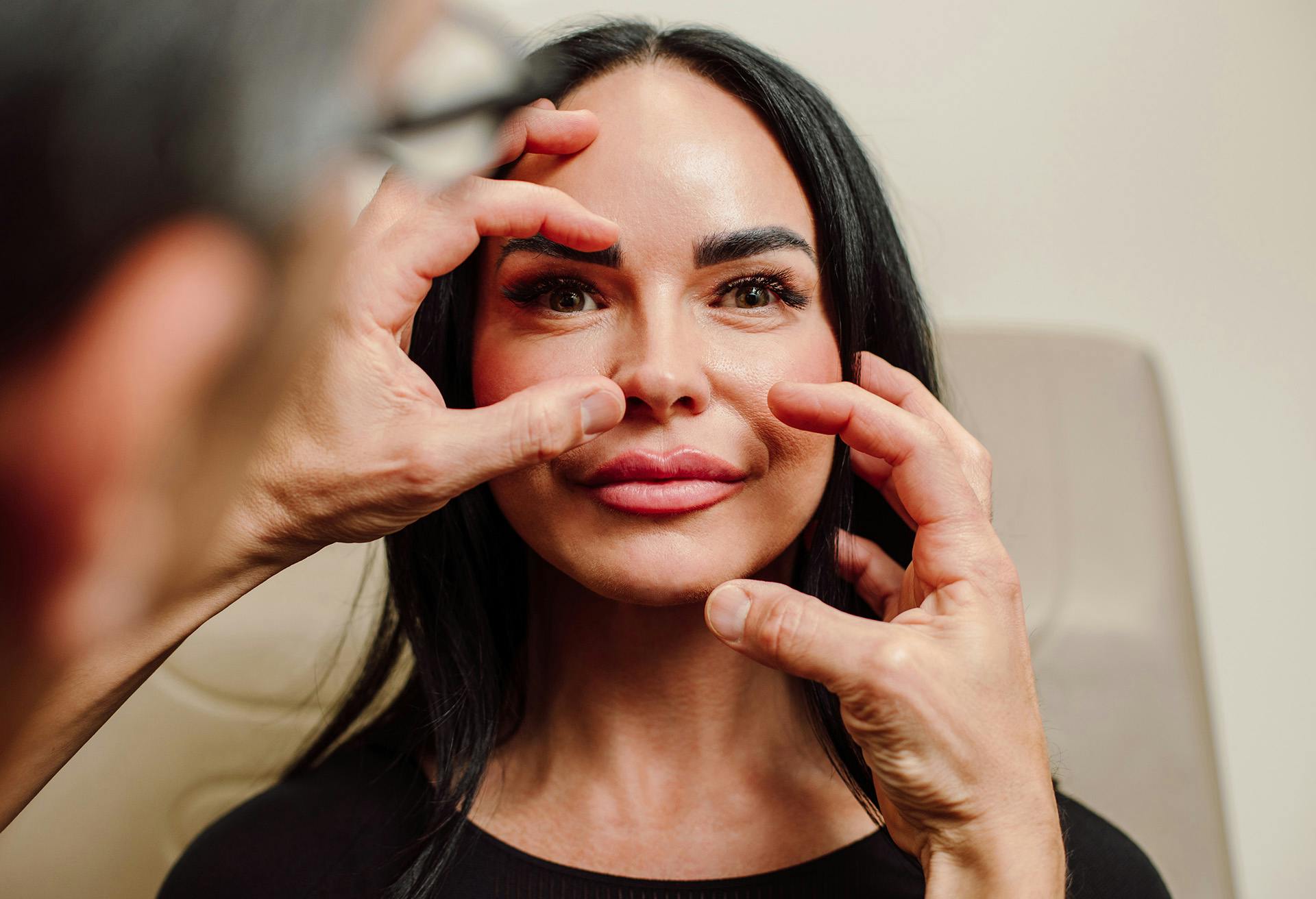 Woman getting her face examined