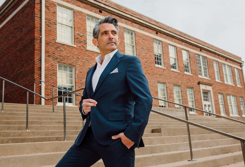 Dr. Ricardo A. Meade in a suit standing on a set of stairs