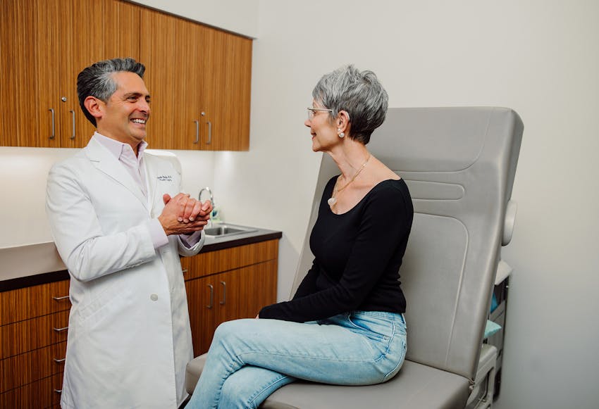 Doctor talking to a woman in a chair