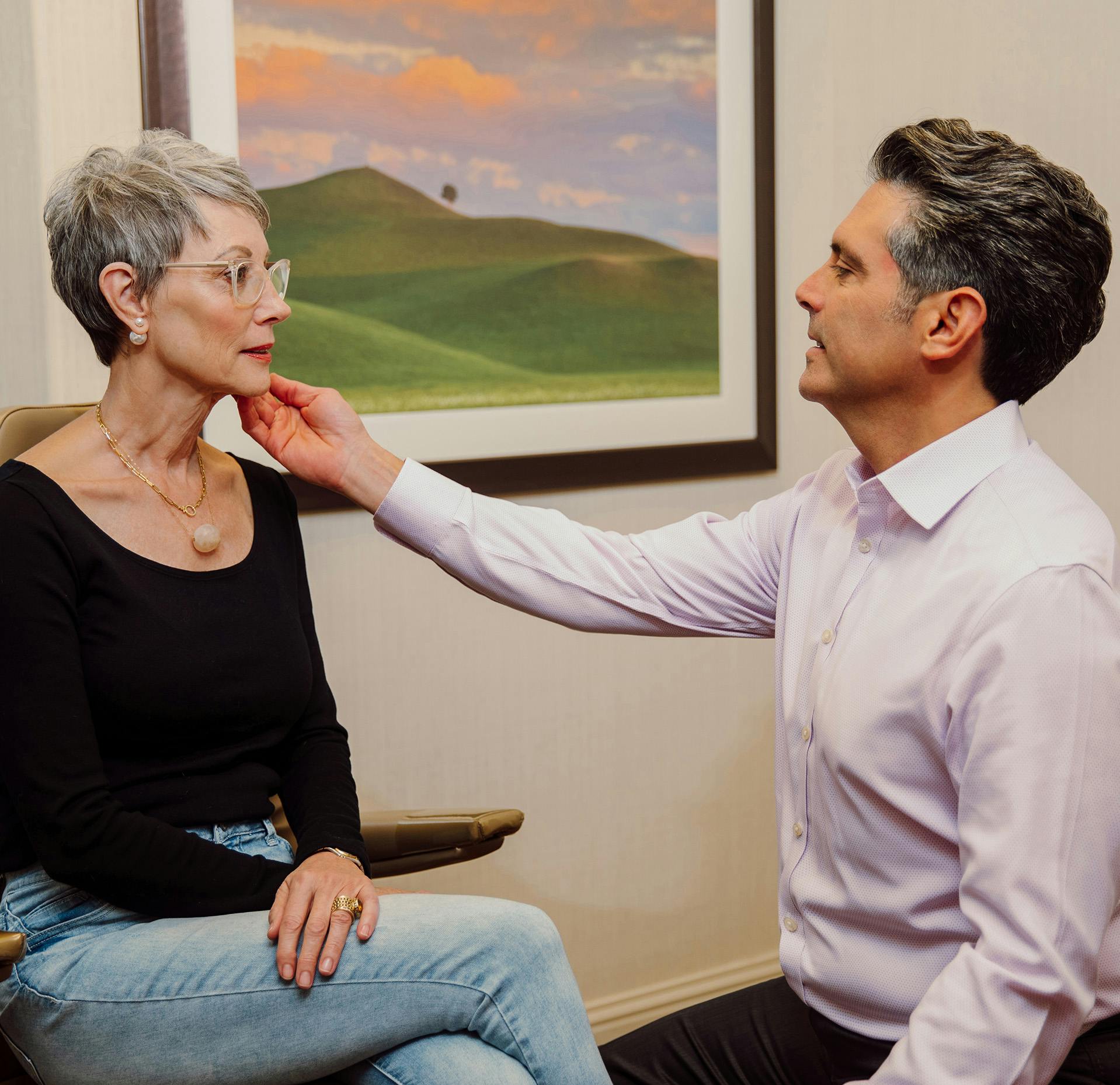 Dr. Ricardo A. Meade holding patient's head by the chin