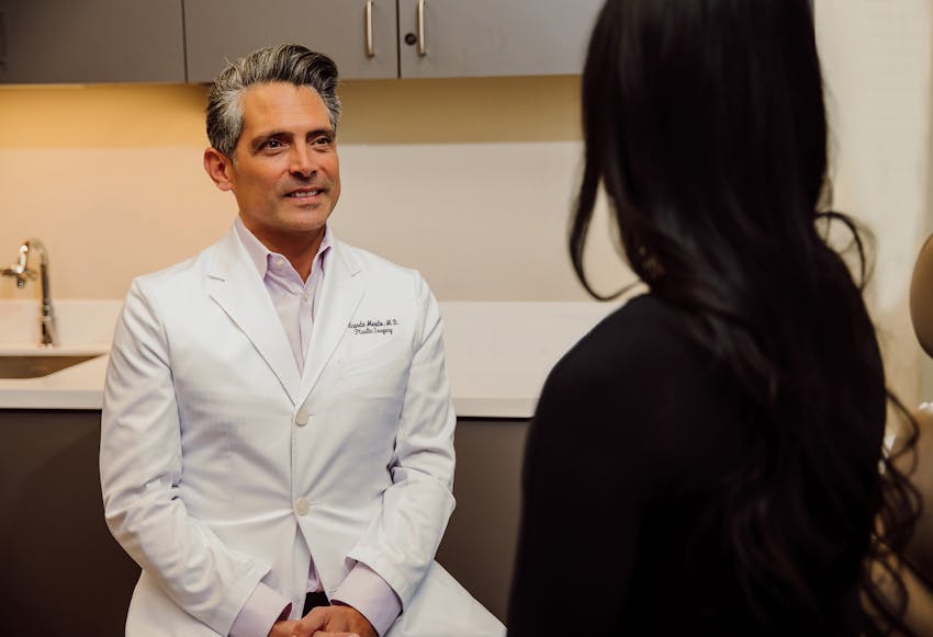 Dr. talking to a woman with black hair