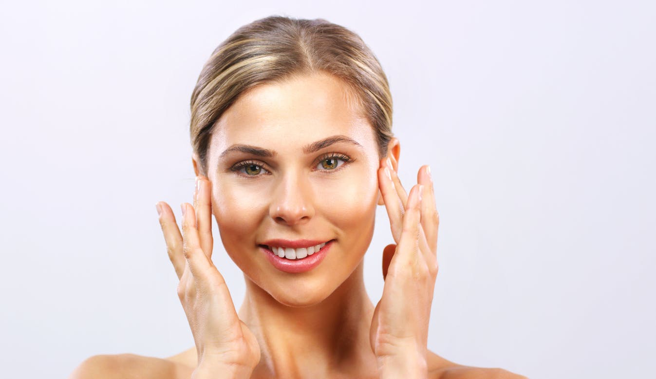 Beautiful woman touching her face.