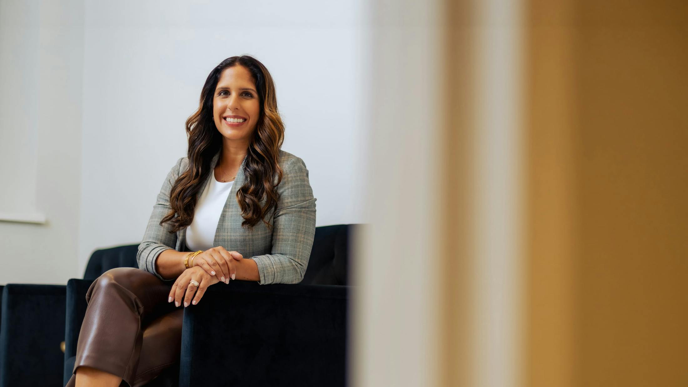 Dr. Sonia Bahlani Sitting in chair smiling