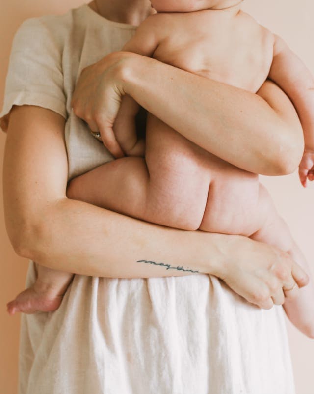 A mother holding a baby in her arms