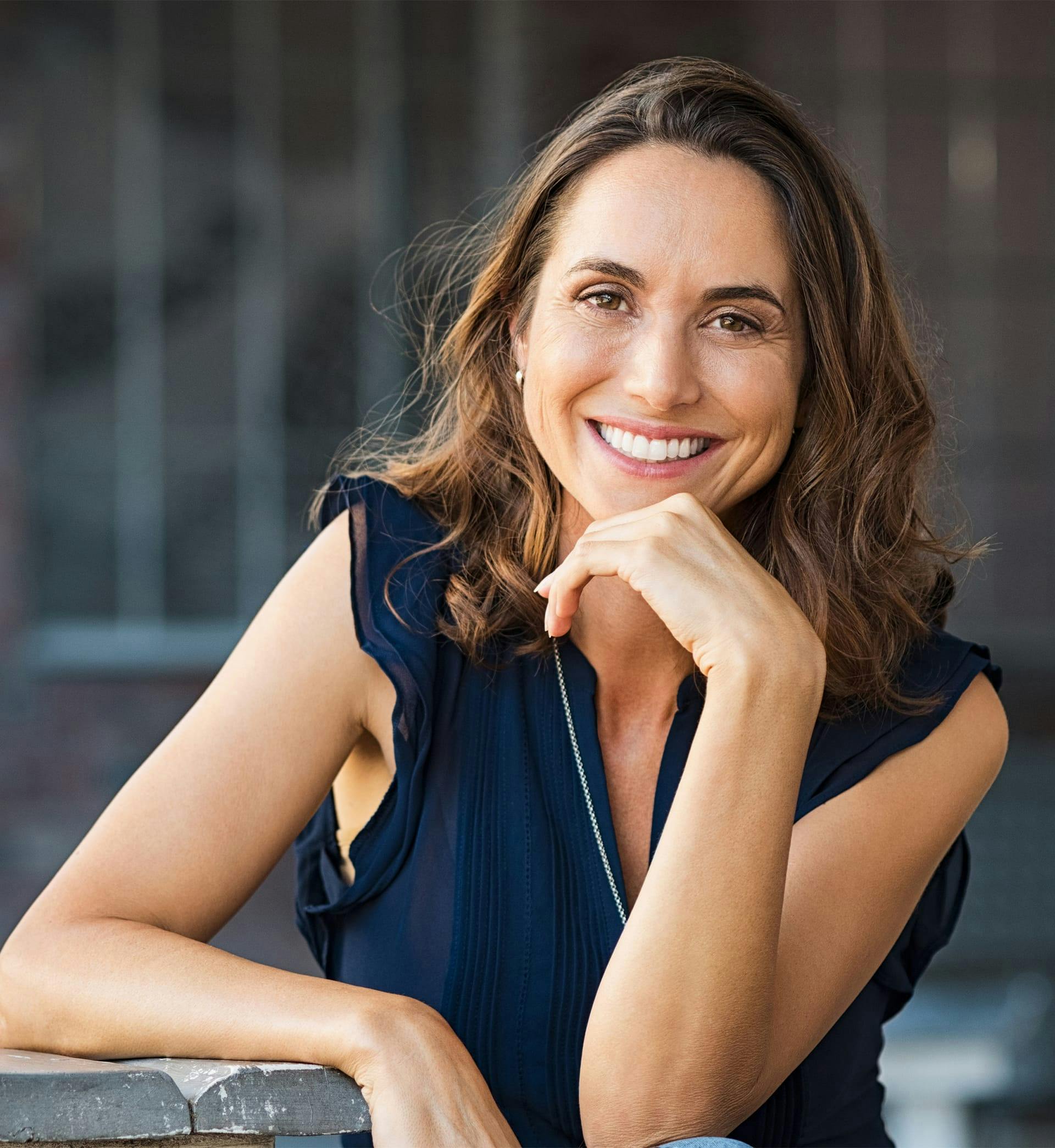 A woman holding hand to her chin