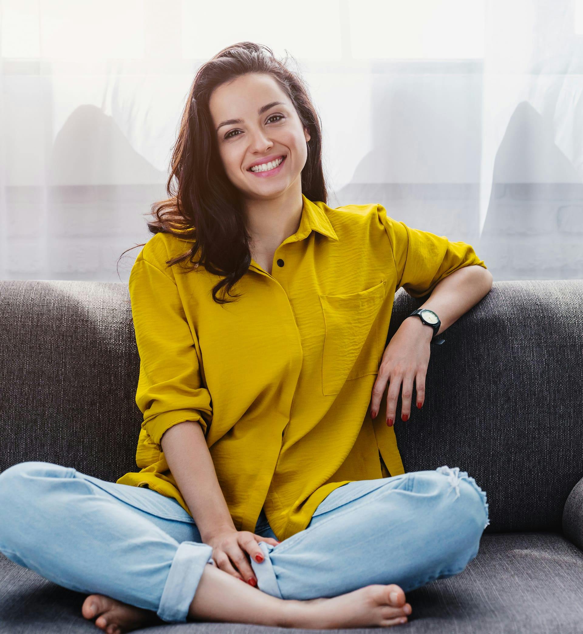 Woman sitting on couch smiling