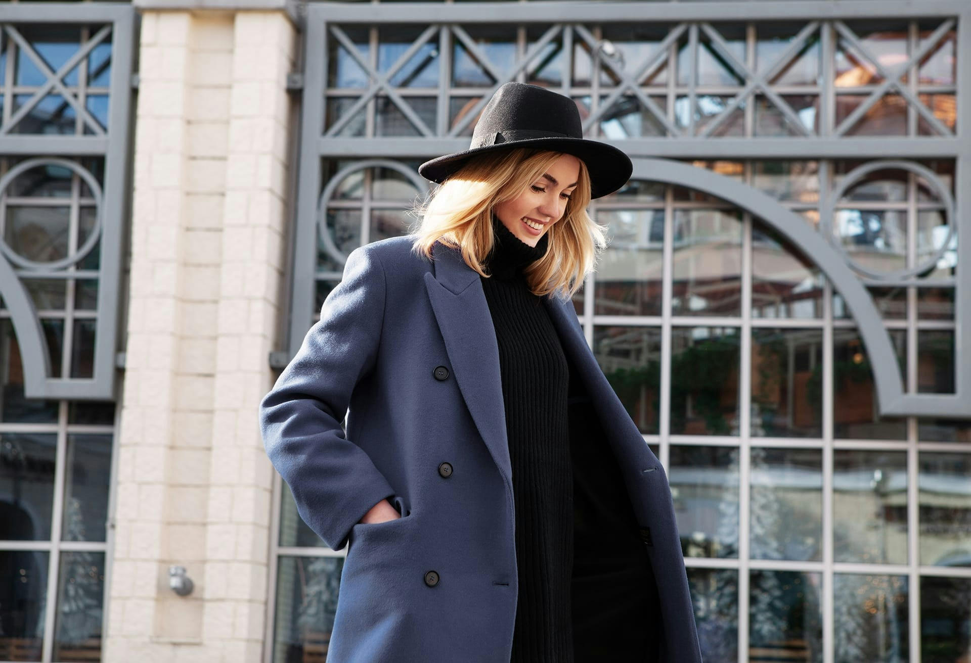 Woman in large coat and hat