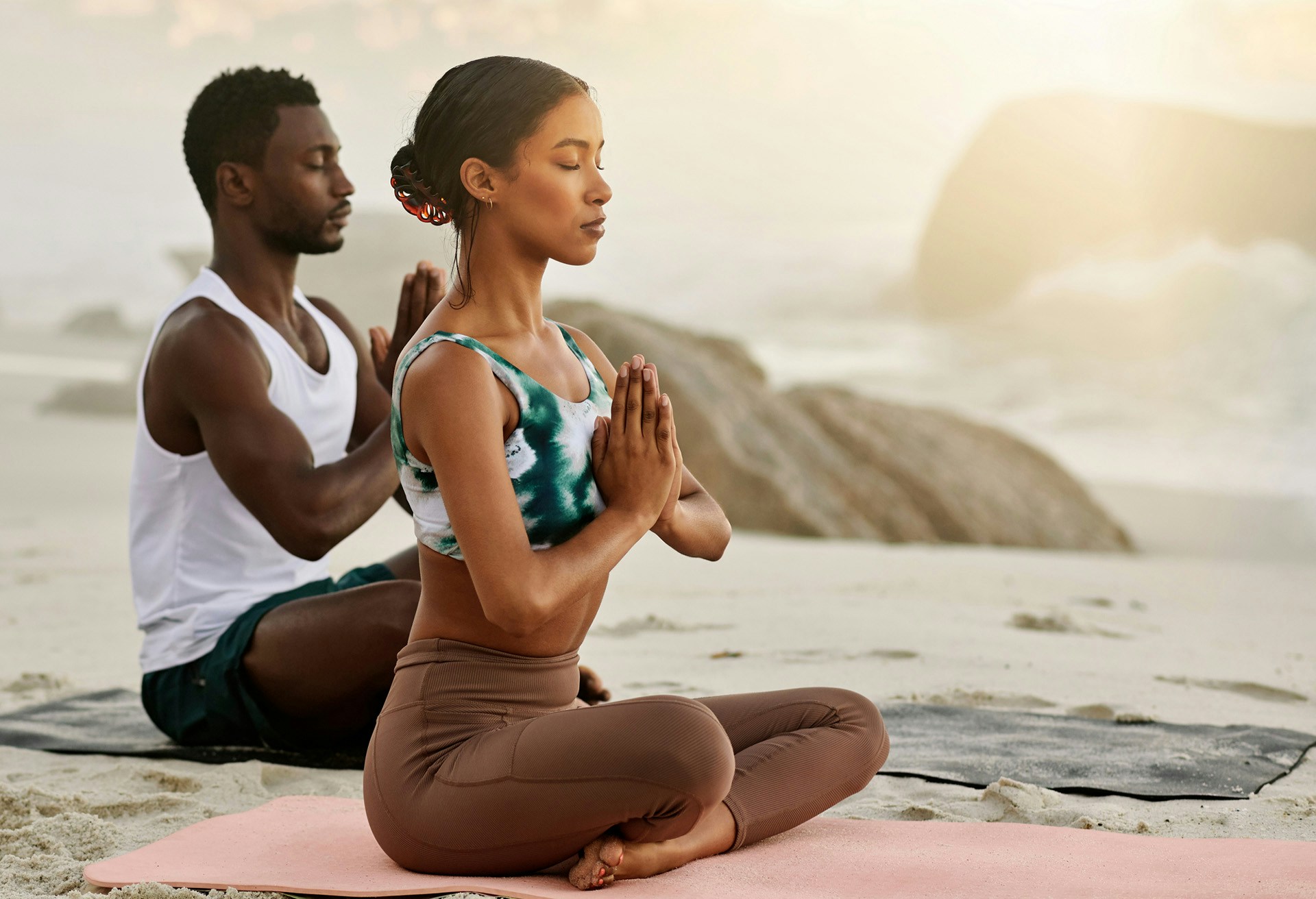 Woman at the beach doing yoga