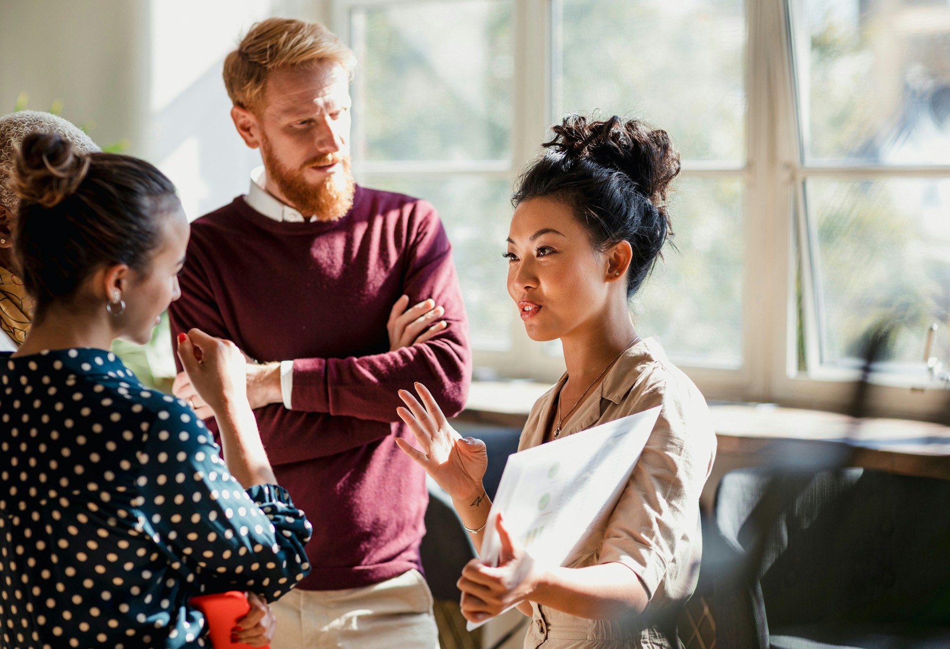 Woman having a discussion with two colleagues