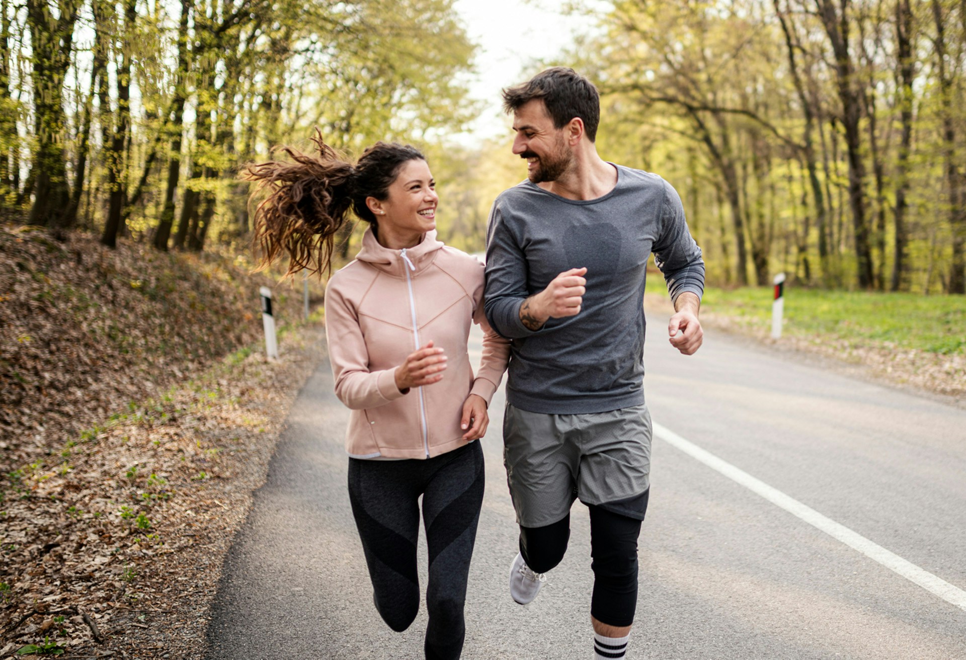 Man and woman running together smiling