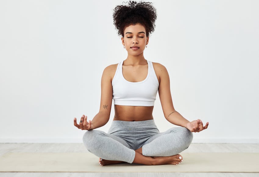 Woman sitting down meditating