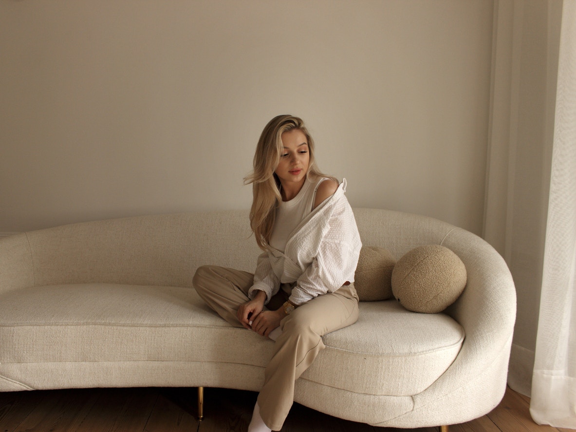 Woman in comfy clothes sitting on a couch