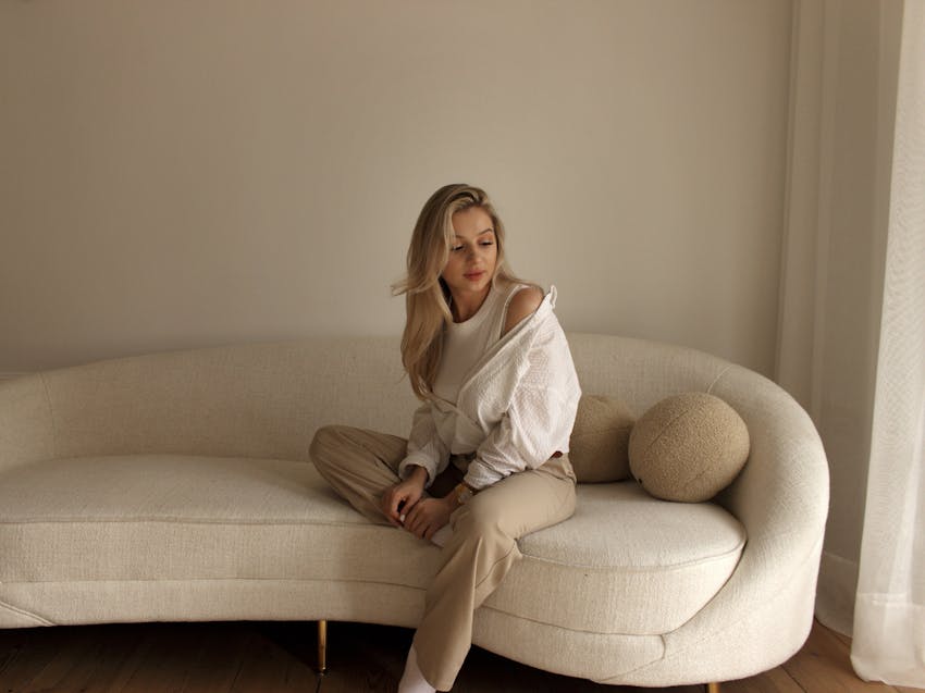 Woman in comfy clothes sitting on a couch