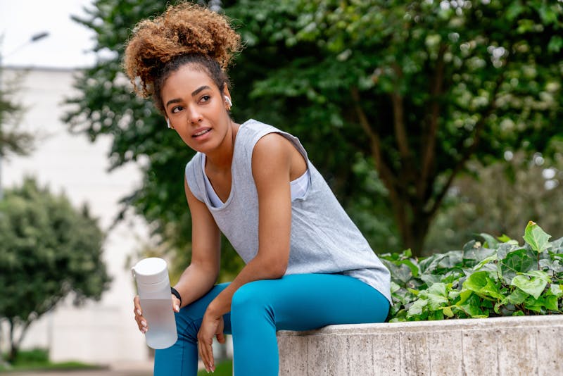 sporty woman drinking water