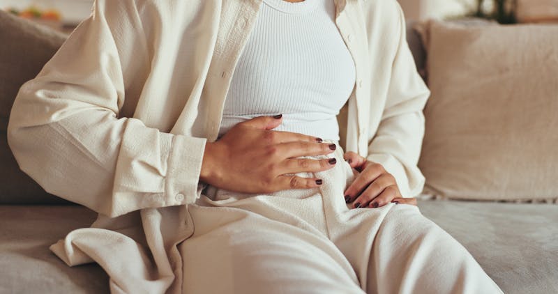 Woman holding uterus in pain
