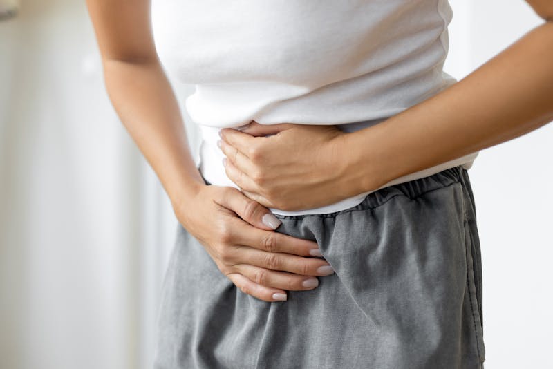 Woman holding stomach in pain