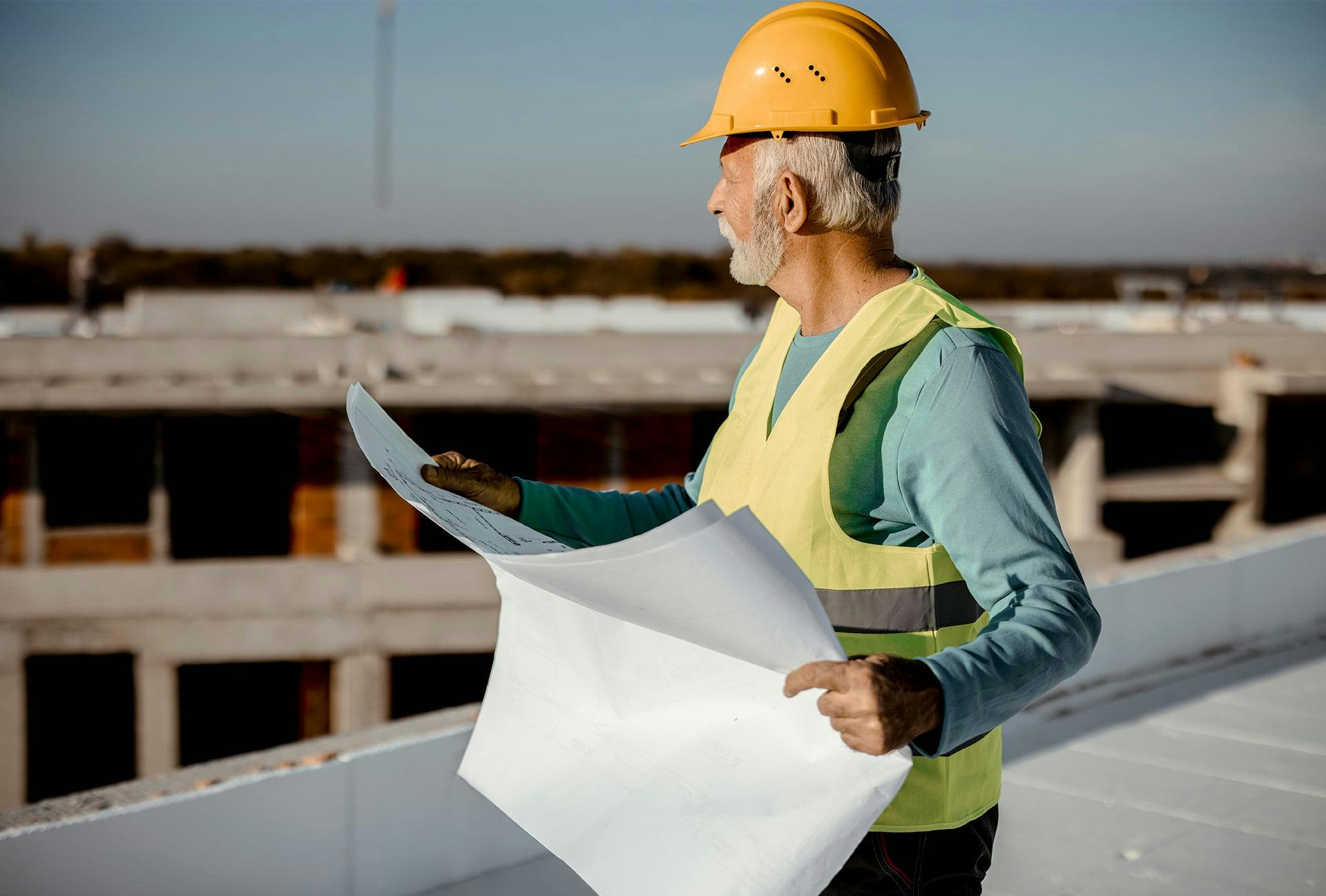 Man holding construction plans