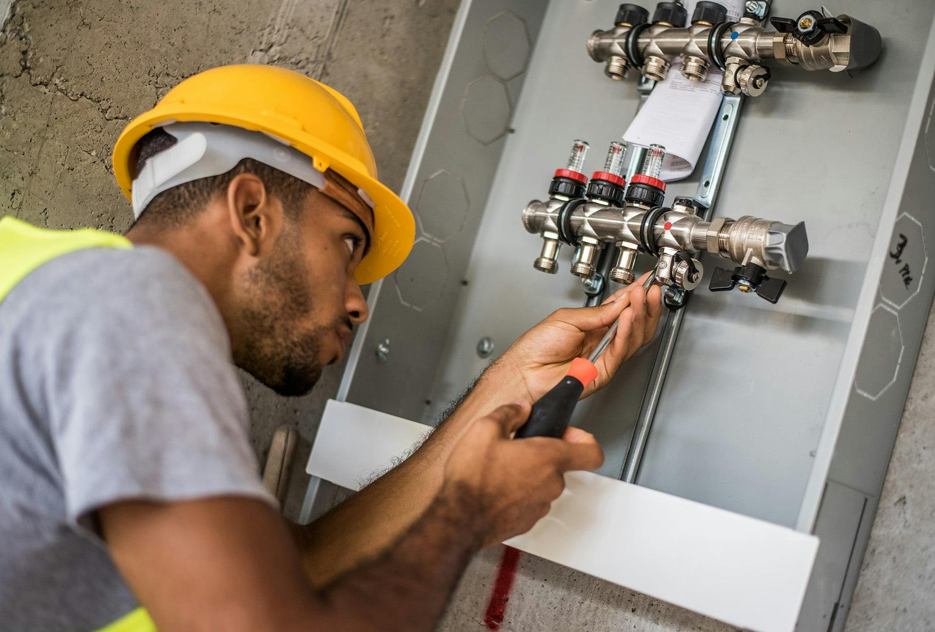 Plumber working on fittings